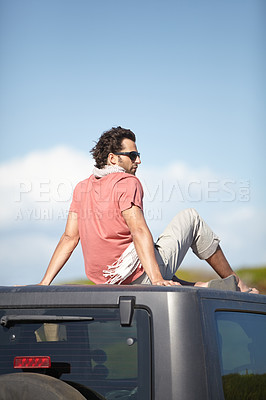 Buy stock photo Road trip, man and sitting on van roof for scenery, nature and fresh air on adventure or vacation in South Africa. People, tourist or traveler on rooftop of van with sunglasses for view or journey