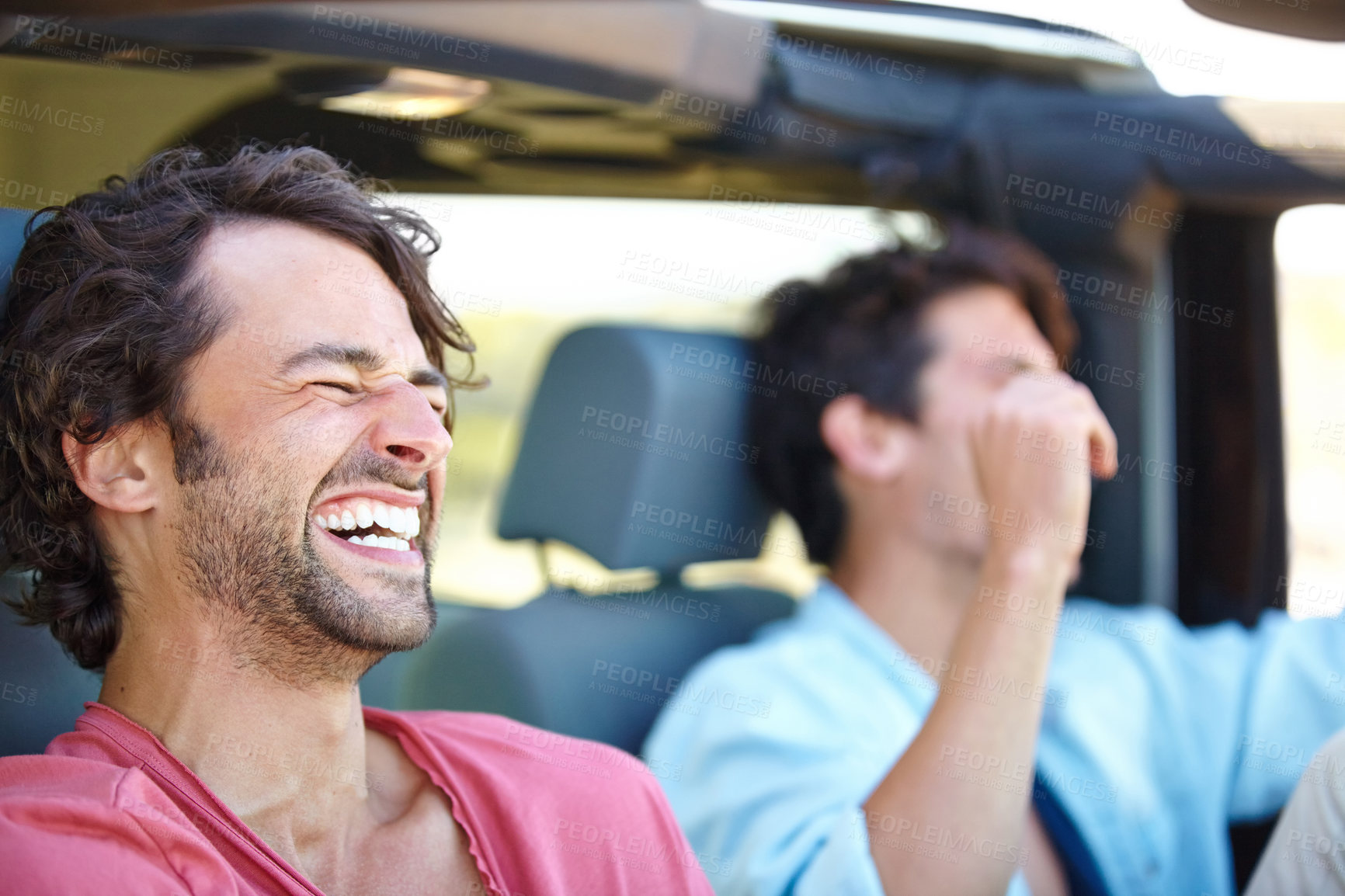 Buy stock photo Two friends happy and laughing together while on a drive