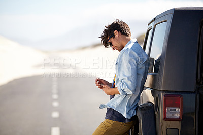 Buy stock photo A young man phoning for roadside assistance