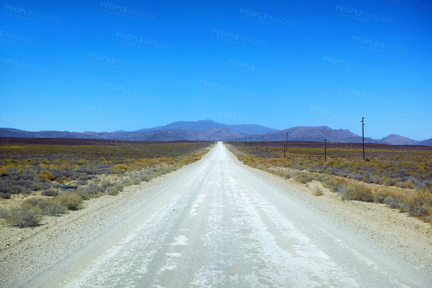 Buy stock photo Dirt road in arid and barren highland in Savanna Desert in rural South Africa with copyspace. Dry, empty, remote land against blue sky. Global warming and climate change in drought environment