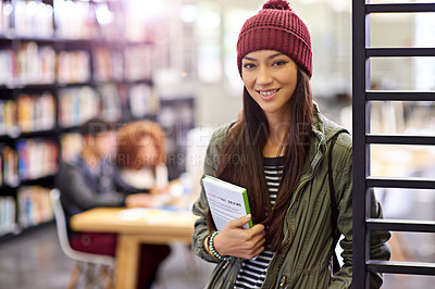 Buy stock photo Woman in portrait, student in library with book and study for exam with smile on university campus. Education, learning and academic development with female person holding textbook for knowledge