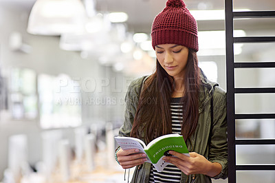 Buy stock photo Woman with book, student in library reading and study for exam or research on university campus. Education, learning and academic development with female person holding textbook for knowledge