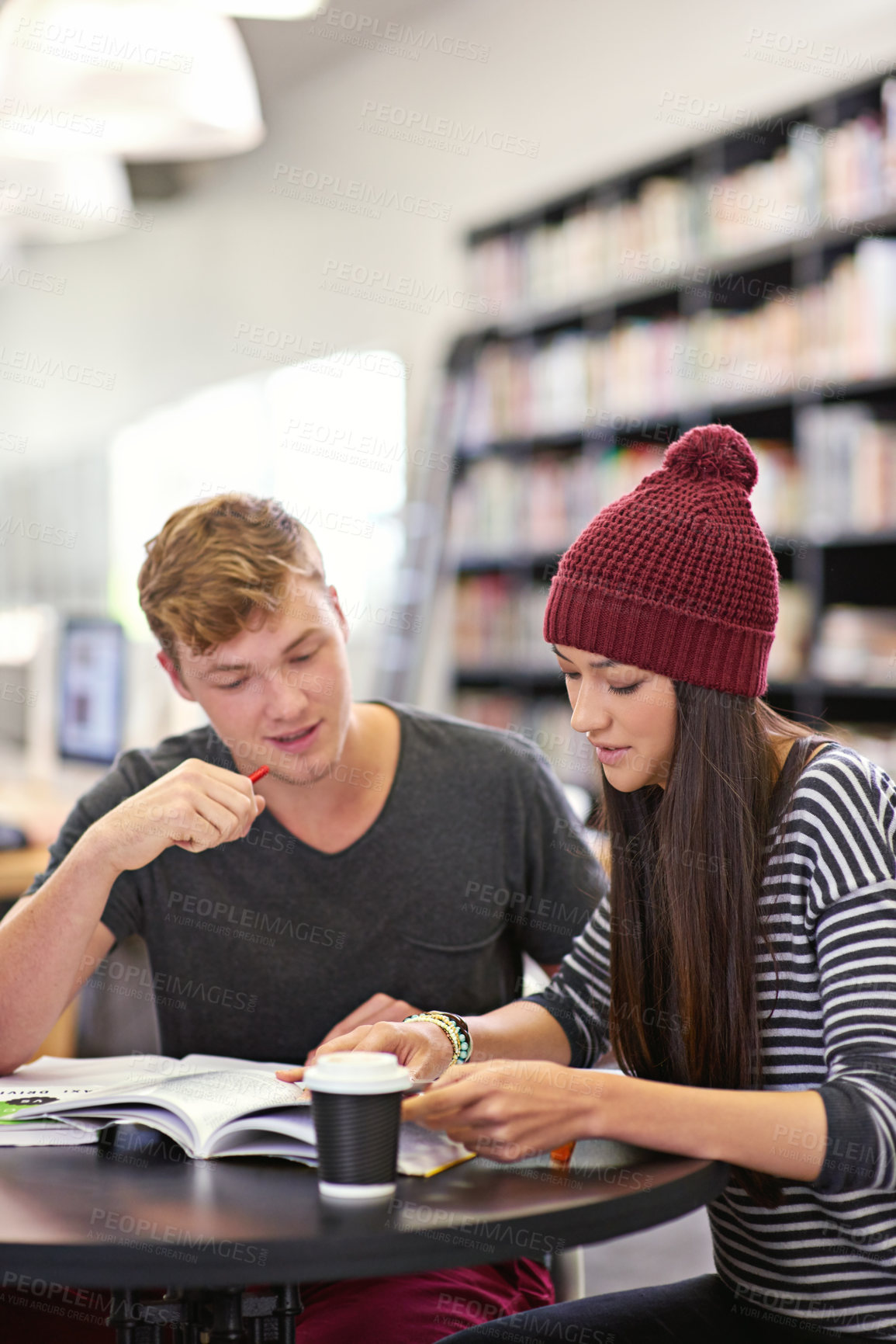 Buy stock photo Students, boy and girl for teamwork in library for assignment, academic research and education. Campus, college or university for knowledge, learning and friends with discussion for essay assessment