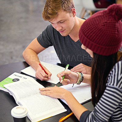 Buy stock photo Shot of two college students studying together at the library
