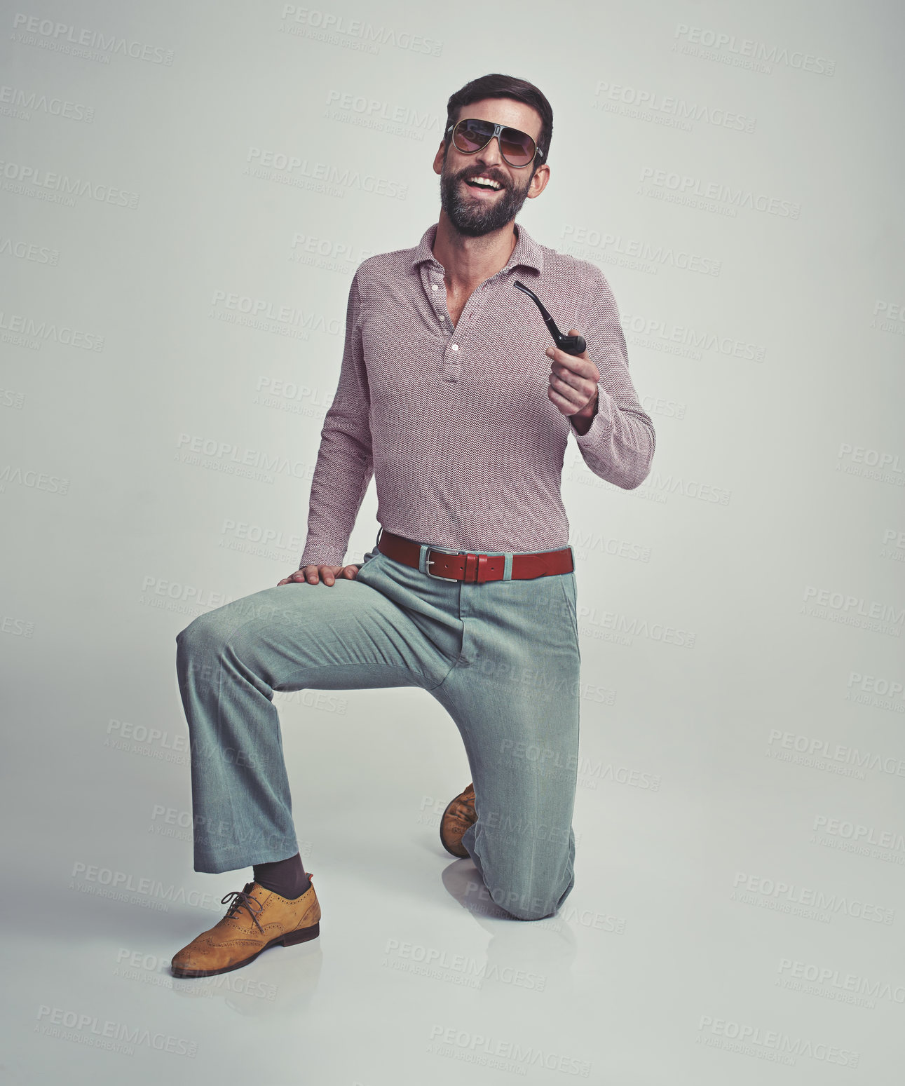 Buy stock photo Studio shot of a handsome man striking a pose while wearing retro 70s style clothing