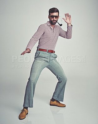 Buy stock photo Studio shot of a handsome man striking a pose while wearing retro 70s style clothing