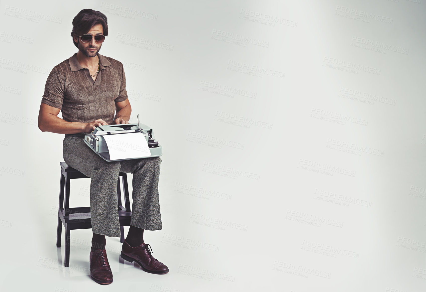 Buy stock photo Man, fashion and vintage with typewriter in studio on grey background, confident and typing in chair. Mockup, writer, and manuscript in retro look with smart style in elegance, clothes and glasses