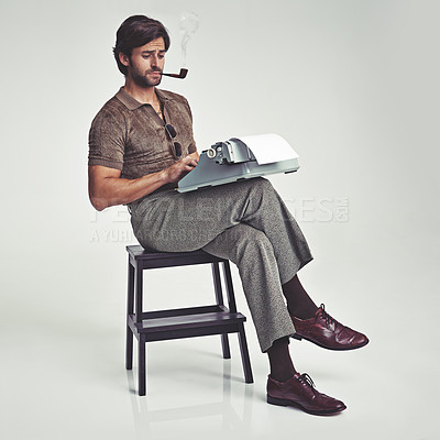 Buy stock photo Studio shot of a 70's style businessman sitting on a stool using a typewriter