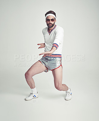 Buy stock photo A young man in the studio wearing retro sportswear and shades