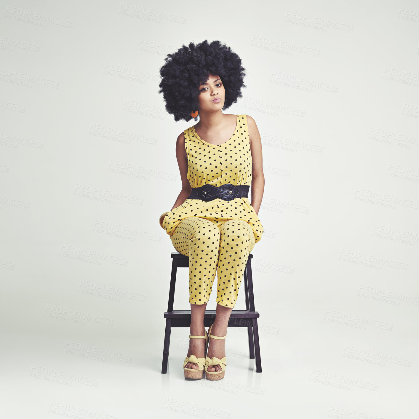 Buy stock photo Woman, afro and retro for fashion, studio and clothes of vintage, chair and portrait in color.  African person sitting in front of backdrop, white background and model with hair for power and edgy