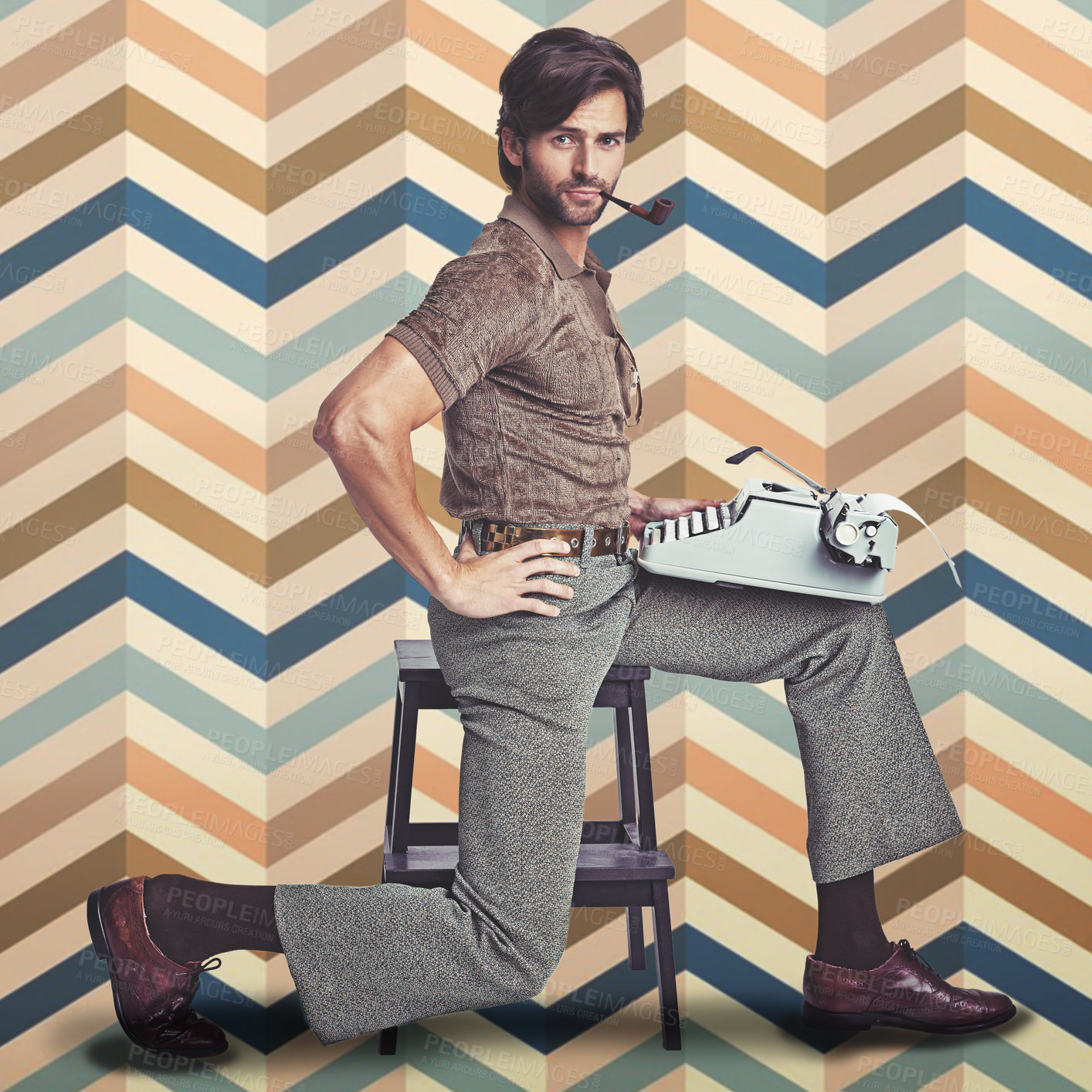 Buy stock photo A handsome man holding a retro typewriter and smoking a pipe while striking a pose