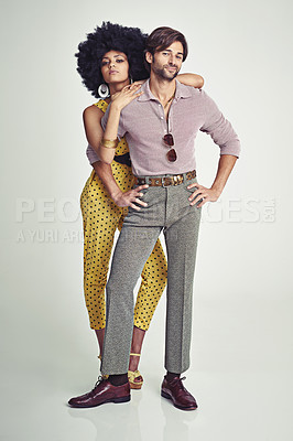 Buy stock photo Couple, portrait and fashion in confidence for style, outfit or clothing on a gray studio background. Young interracial man and woman in stylish retro or vintage pants, shirt or jumpsuit with jewelry