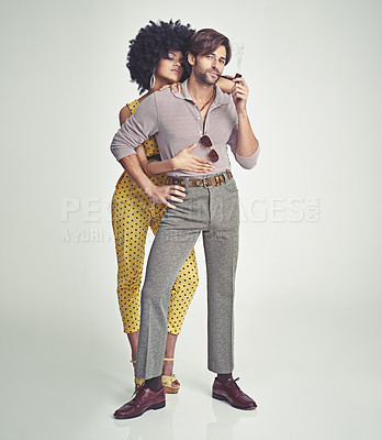 Buy stock photo An attractive young couple standing together in retro 70s clothing