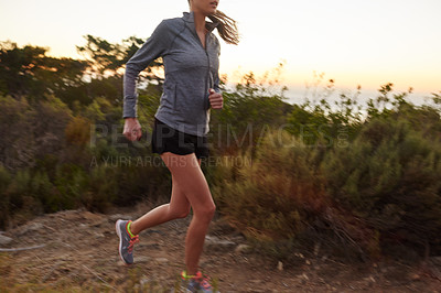 Buy stock photo Cropped shot of a woman jogging outdoors