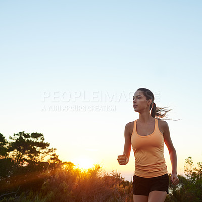 Buy stock photo Cropped shot of a young woman jogging outdoors
