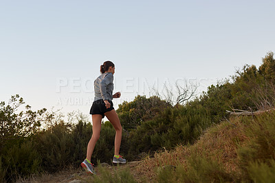 Buy stock photo Rearview shot of a young female running outdoords