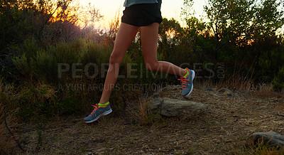 Buy stock photo Low angle shot of a young woman running outdoors