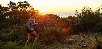 Buy stock photo Shot of a beautiful brunette training outdoors