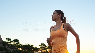 Buy stock photo Shot of a beautiful brunette training outdoors