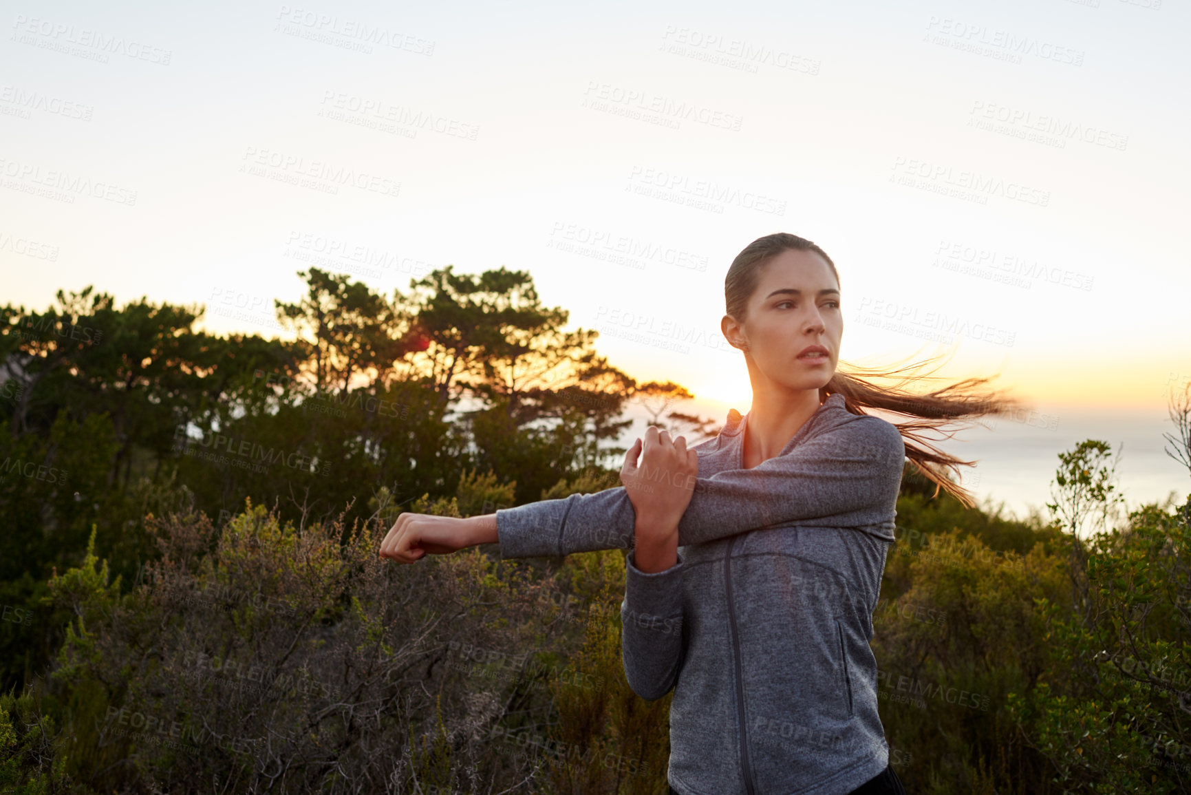 Buy stock photo Stretching, sunset and thinking with runner woman outdoor in nature for start of exercise or fitness. Idea, health and wellness with serious athlete person in park for training, warm up or workout
