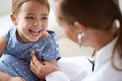 Buy stock photo Happy child, girl and stethoscope of doctor for medical consulting, healthy lungs and listening to heartbeat. Face of laughing kid, pediatrician and chest assessment for healthcare analysis in clinic