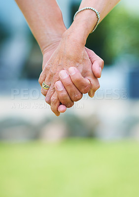 Buy stock photo Couple, travel or holding hands for support in park, nature or outdoors on a romantic walk for love. Wellness, freedom or closeup of man with woman bonding, care or enjoying date together outside