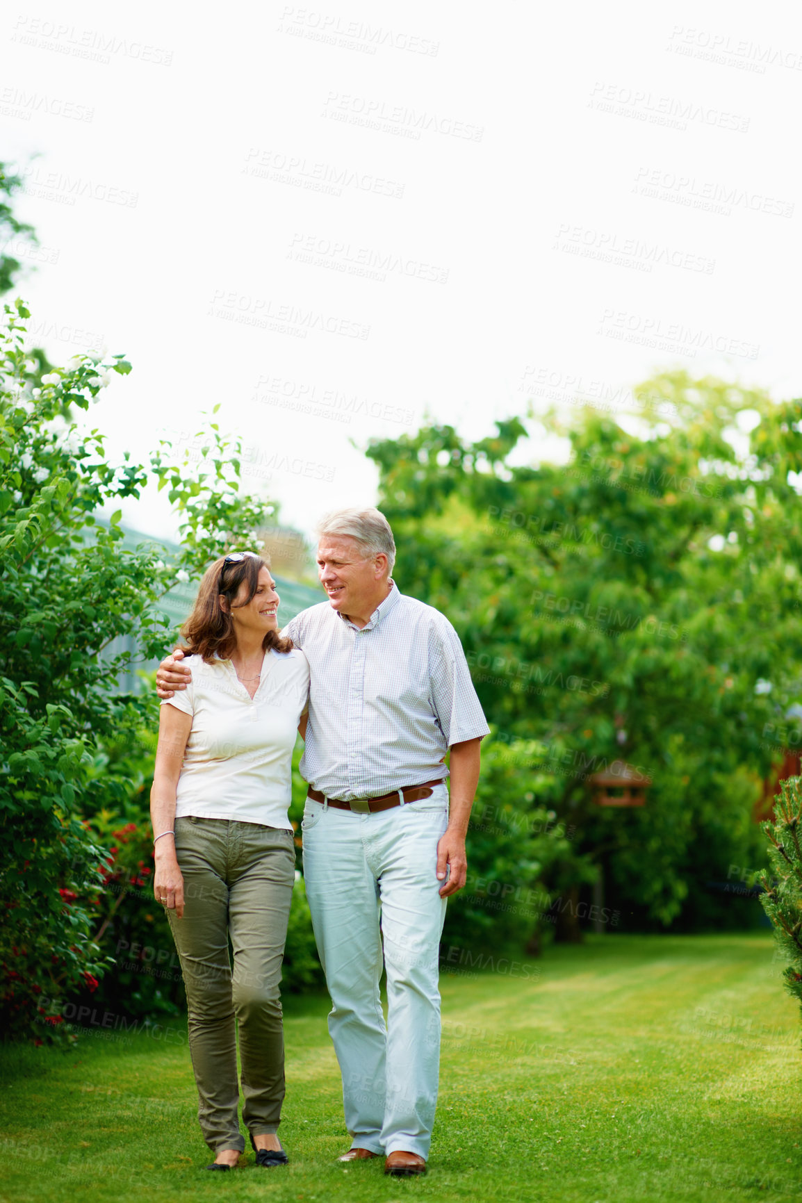 Buy stock photo Mature, holiday or happy couple hug in park or nature on a outdoor romantic walk for support. Wellness, freedom or senior man with woman bonding, care or enjoying date or retirement together outside