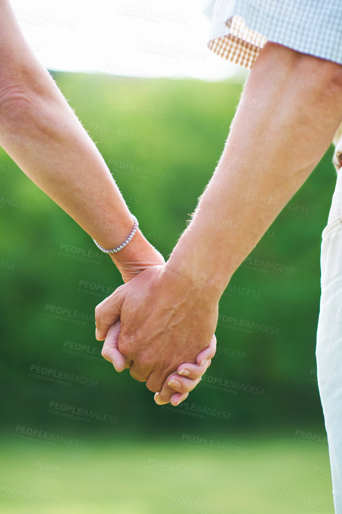 Buy stock photo Couple, holiday or holding hands for love in park, nature or outdoors on a romantic walk for support. Wellness, freedom or closeup of man with woman bonding, care or enjoying date together outside