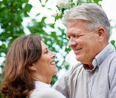 Buy stock photo Senior man, face and love for wife in park, romantic hugging and commitment in marriage. Celebration, happy couple and wellness in nature to connect, bond and together in support partner on vacation