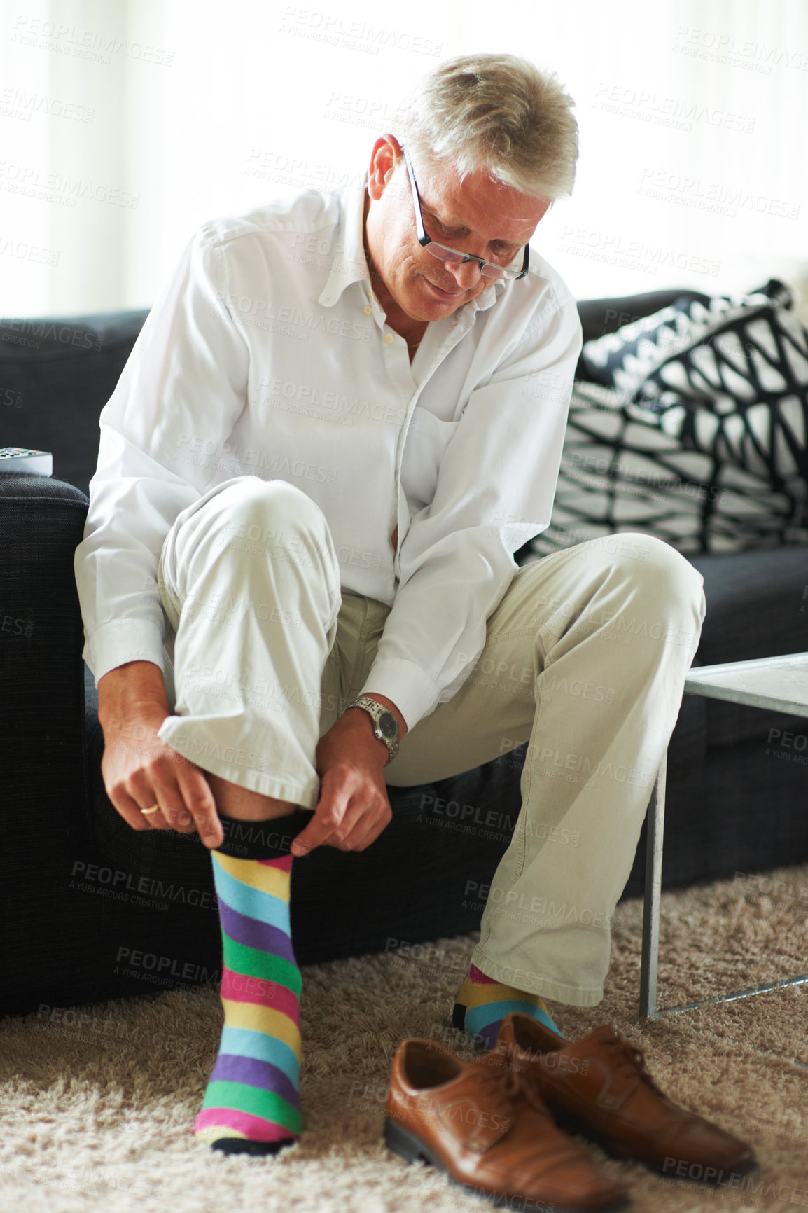 Buy stock photo Mature man dressing, shoes and socks on carpet in home, putting on business fashion and start to day. Businessman getting ready for work in morning, feet on floor with style and wardrobe for office.