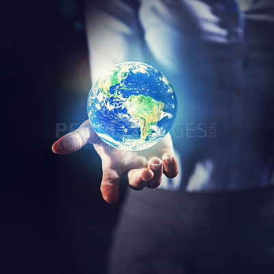 Buy stock photo Shot of a businesswoman holding the earth in her palm