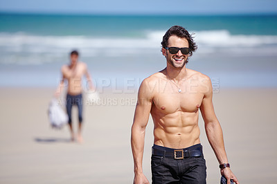 Buy stock photo Portrait, smile and the body of a man on the beach for travel, freedom or adventure on vacation. Summer, sunglasses and a young person shirtless by the ocean or sea on a tropical coast for holiday