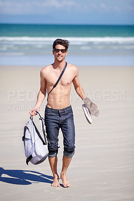 Buy stock photo Portrait, walking and the body of a man on the beach for travel, freedom or adventure on vacation. Summer, sand and sunglasses with a young person shirtless by the ocean or sea for a coastal holiday