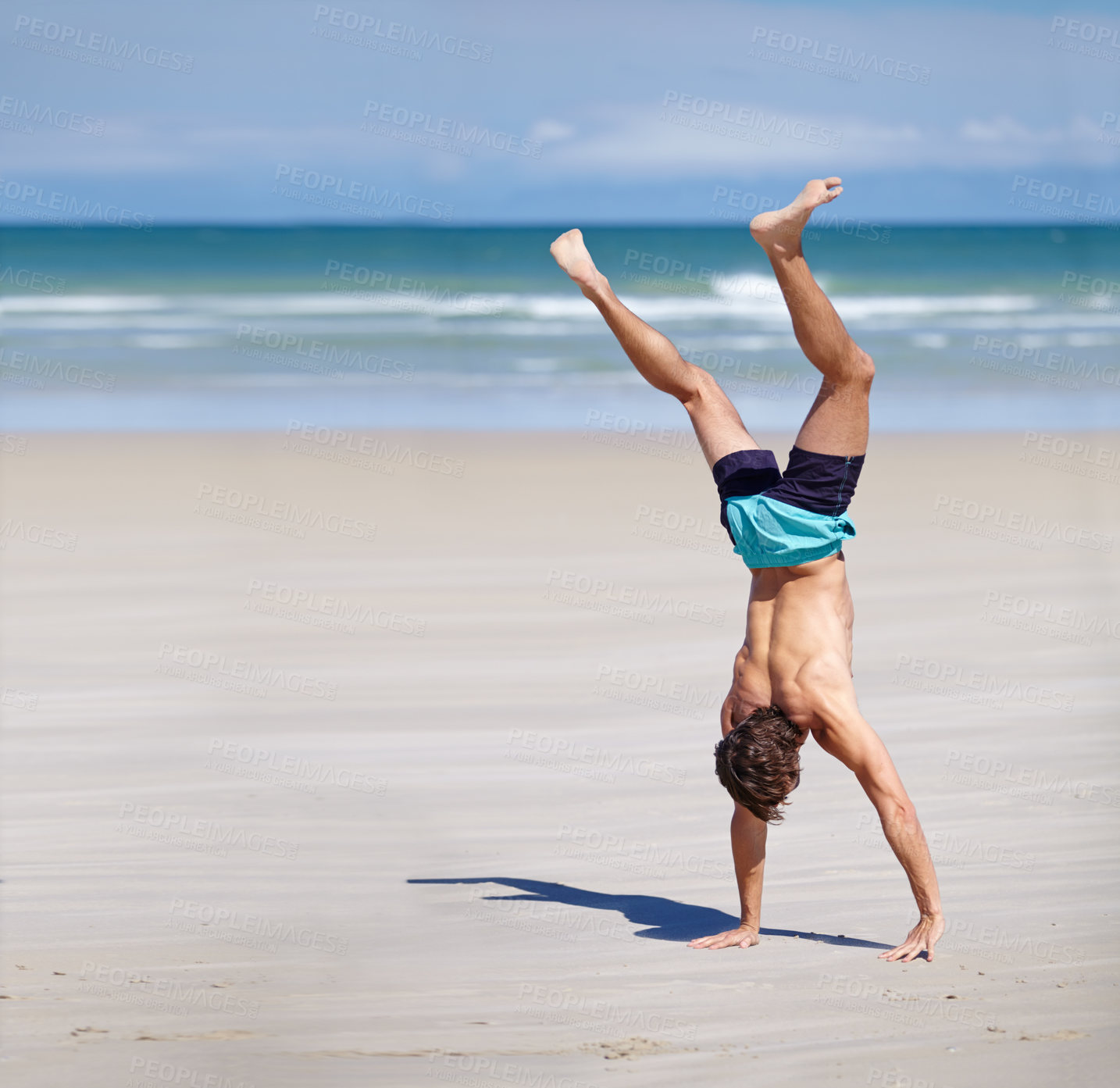 Buy stock photo Man, calisthenics and body at beach sand for exercise with summer, health and mockup. Male athlete, water and hand stand for sports training with sunshine, strong muscles and fun at sea in Brazil