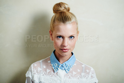 Buy stock photo A young woman with her hair in a bun posing in casual wear