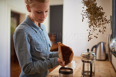 Buy stock photo Woman, coffee beans and grinder in kitchen for drink preparation with plunger for morning, caffeine or latte. Female person, bag and pour in machine on counter for hot beverage, matcha or cappuccino