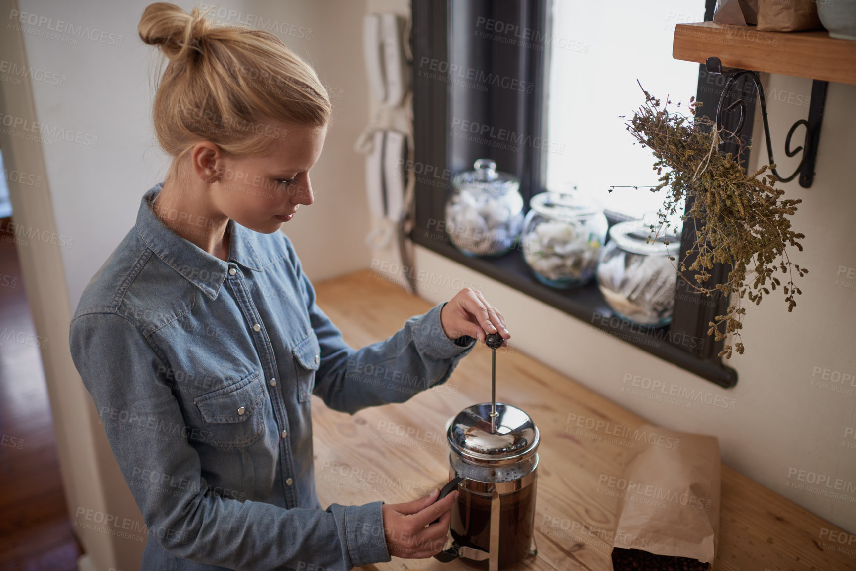 Buy stock photo Woman, coffee and french press in kitchen for beverage in morning for relax on weekend or holiday. Female person, caffeine and plunger on counter for cappuccino drink, latte or preparation at home