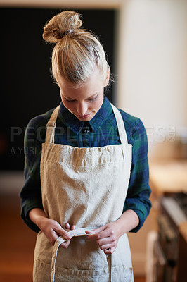 Buy stock photo Chef, woman and tie apron in kitchen, restaurant or catering service at hotel for gastronomy. Uniform, cooking and person with knot on clothes, culinary or preparation of professional waitress at job