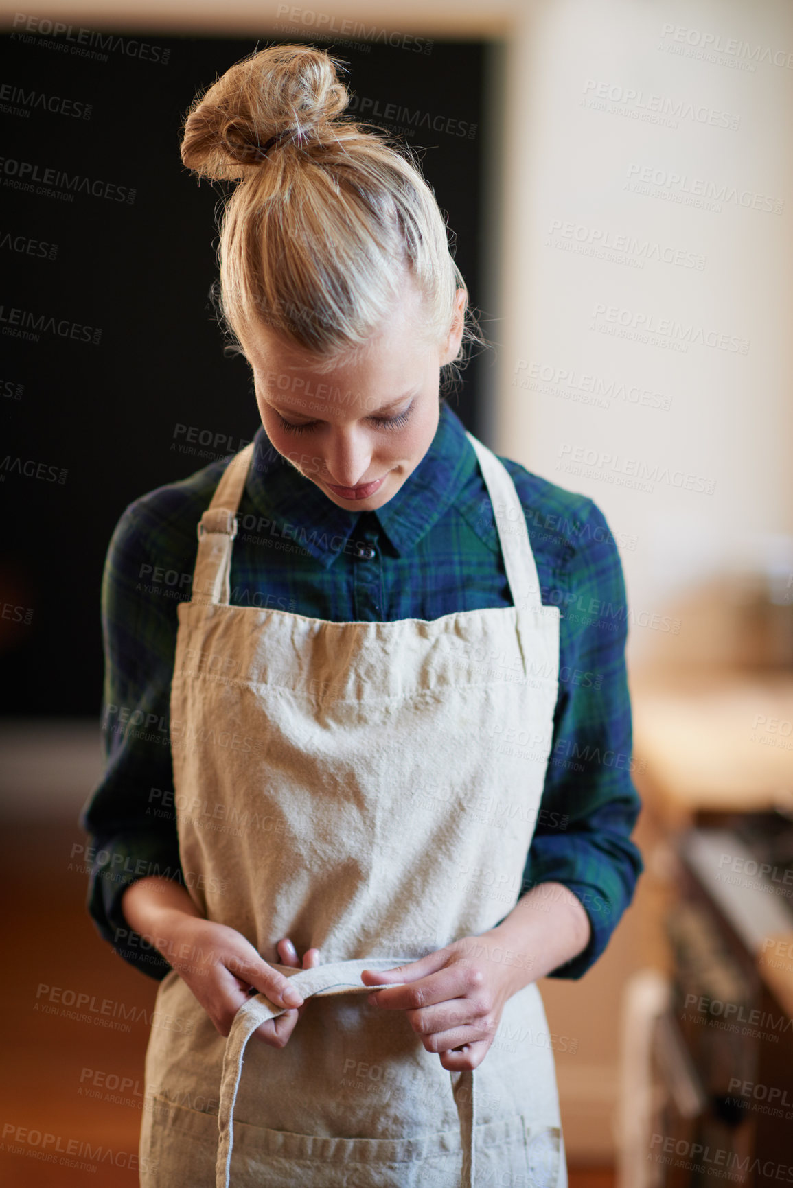 Buy stock photo Chef, woman and tie apron in kitchen, restaurant or catering service at hotel for gastronomy. Uniform, cooking and person with knot on clothes, culinary or preparation of professional waitress at job