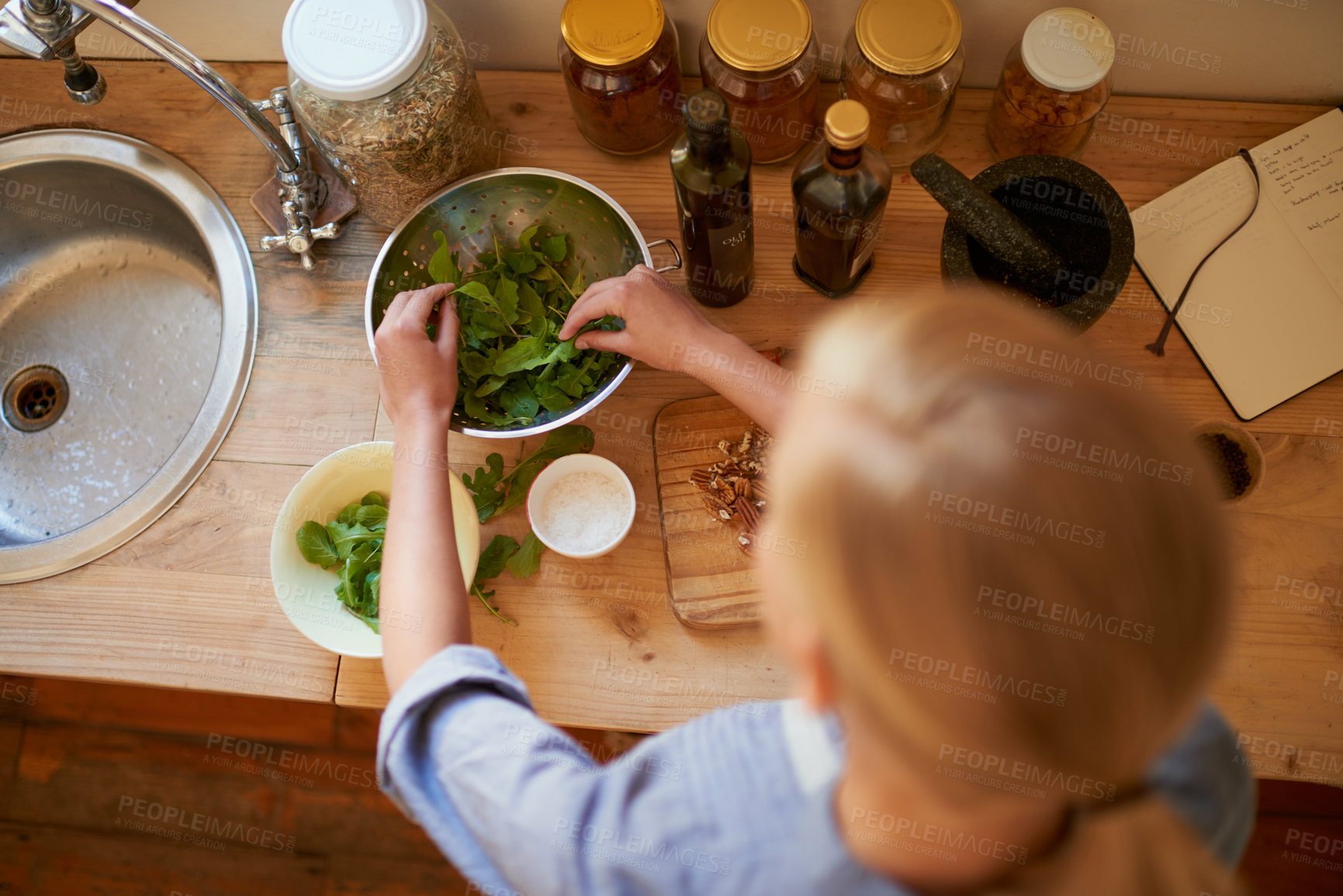 Buy stock photo Cooking, woman and salad leaves in home with diet, nutrition and healthy food from above. Kitchen and green for organic and vegan lunch with bowl and wood board in house with health and wellness