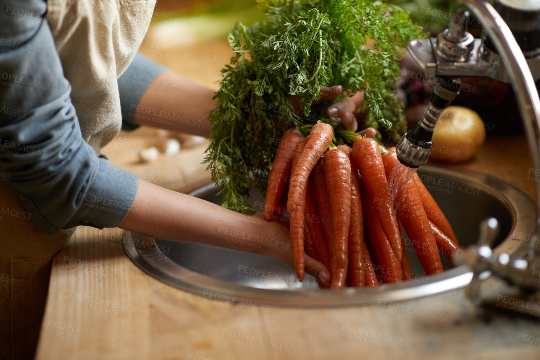 Buy stock photo Person, carrots and washing in sink as vegetable nutrition for wellness ingredient for healthy, salad or organic. Hands, water and clean in kitchen for meal preparation with recipe, vitamins or fibre