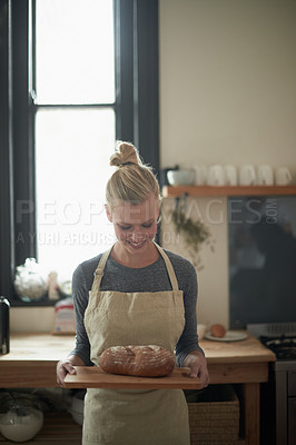 Buy stock photo Shot of a young female baker with homemade bread