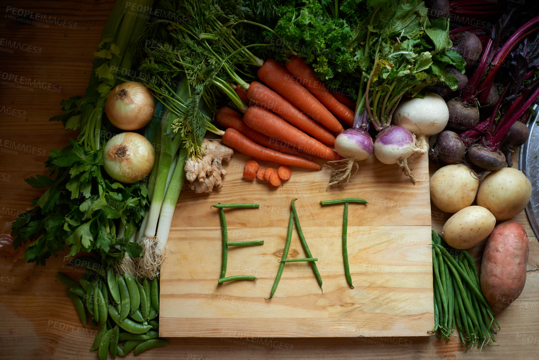 Buy stock photo Food, chopping board and message for eating, wellness and cooking for wellbeing or hunger. Home, nutrition and vegetables for diet, health and vitamins in kitchen for vegan, vitality and still life