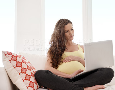 Buy stock photo Laptop, relax and pregnant woman on sofa in home reading online blog for prenatal health advice. Technology, rest and female person with pregnancy in living room for maternity bonding or connection.