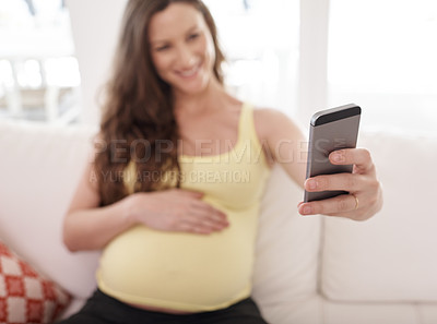 Buy stock photo Pregnant woman, selfie and hand on sofa in home, smile and touch belly for connection with baby. Person, mother and excited with expectation, stomach and happy for post on social network in house