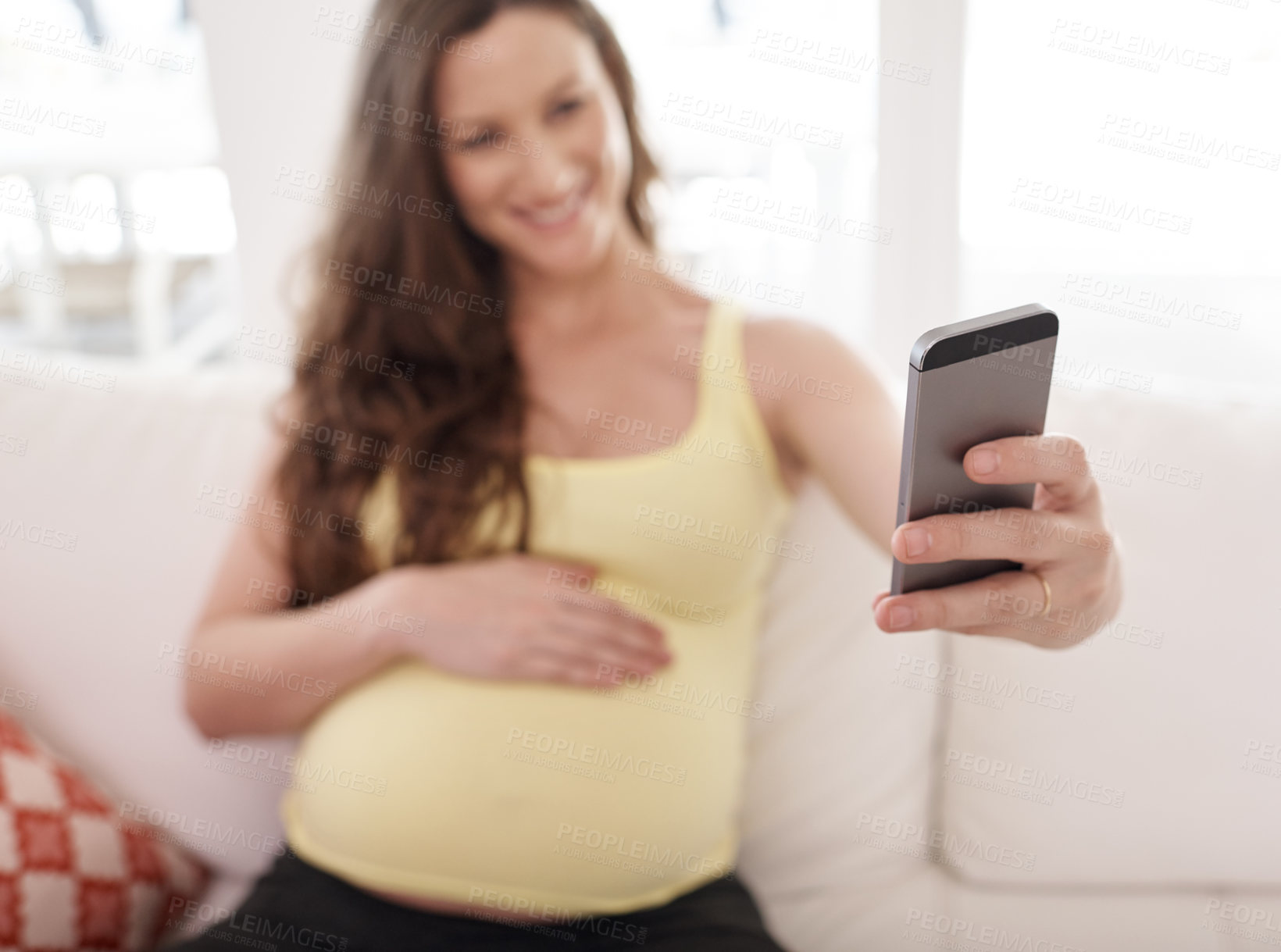 Buy stock photo Pregnant woman, selfie and hand on sofa in home, smile and touch belly for connection with baby. Person, mother and excited with expectation, stomach and happy for post on social network in house