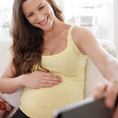 Buy stock photo Pregnant woman, selfie and smile on couch in home, memory and touch belly for connection with baby. Person, mother and excited with expectation, stomach and happy for post on social network in house