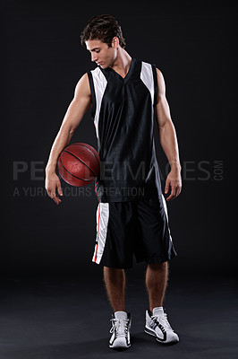 Buy stock photo Full length studio shot of a basketball player standing with his ball against a black background