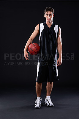 Buy stock photo Full length studio portrait of a basketball player standing with his ball against a black background