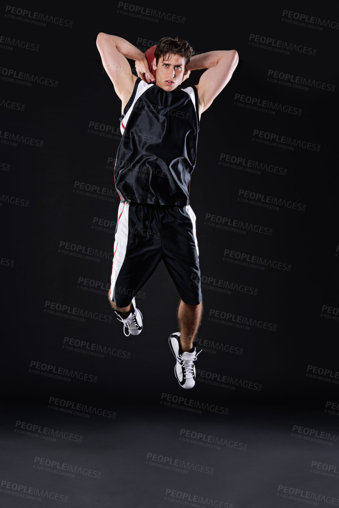 Buy stock photo Full length studio shot of a young male basketball player in action against a black background